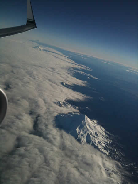 Mt. Hood, Mt. Jefferson, and the Three Sisters with clouds overbreaking